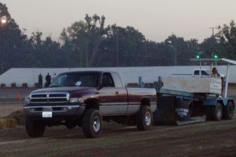 1994 Ford F-150 - A 1994 Dodge Ram pickup truck is seen towing a trailer. The truck's license plate is visible.