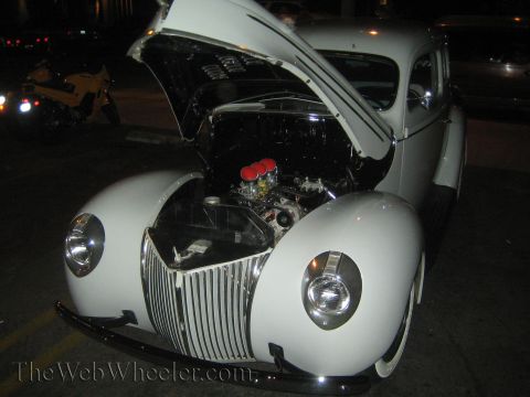 1968 Ford Mustang - A white 1939 Ford sedan is shown with its hood open, displaying the engine and chrome details.
