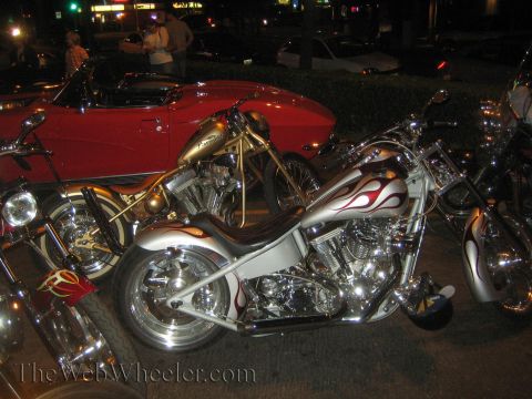 1968 Ford Mustang - Custom choppers and a red classic car are parked together at night.