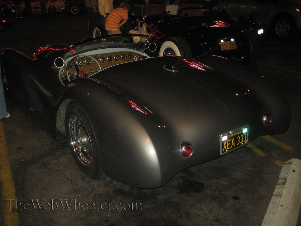 Dark gray convertible sports car rear view, California license plate XEA 333
