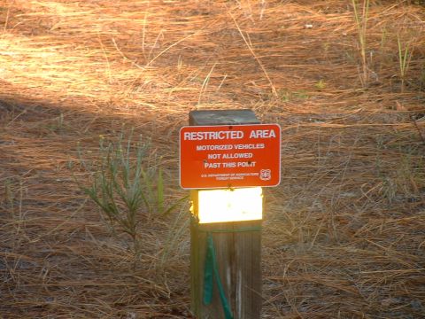 1995 Ford Bronco - A sign warns that motorized vehicles are not allowed past this point in a forest service area.