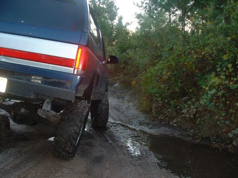 1995 Ford Bronco - This 1995 Ford Bronco is seen from the rear on a muddy, wooded trail.