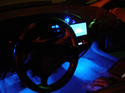 1993 Ford Taurus - Interior view of a car with blue underglow lighting on the dashboard and floor.