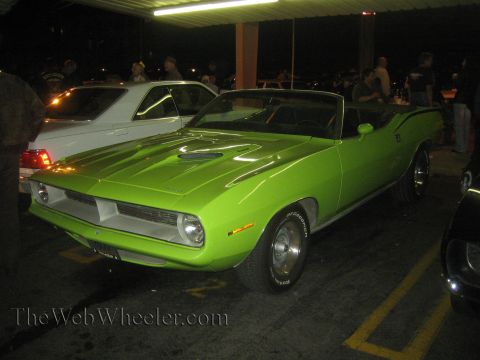 1968 Ford Mustang - A bright green 1970 Plymouth Barracuda convertible is parked in a lot at night.