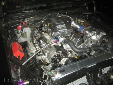 1968 Ford Mustang - Close-up of a modified V8 engine a Vortech supercharger and custom exhaust headers.