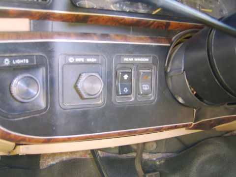 1989 Ford Bronco - Close-up of the left-hand dash switch panel in a Ford truck interior, showing the LIGHTS headlight knob, WIPE-WASH wiper knob and REAR WIND…