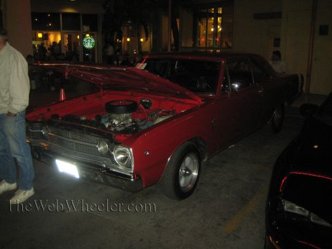 1968 Ford Mustang - A red 1967 Dodge Dart GTS is parked outside at night with its hood open, revealing the engine.