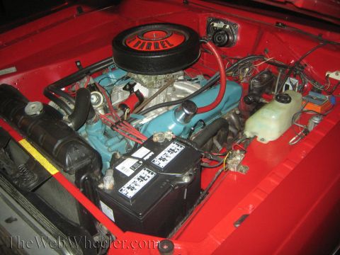 1968 Ford Mustang - The engine bay of a 1968 Ford Mustang shows a blue engine with a '2-BARREL' air cleaner and a black battery.
