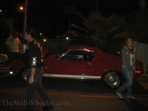 1968 Ford Mustang - A red 1968 Ford Mustang GT500 KR is seen parked at night with white side stripes.