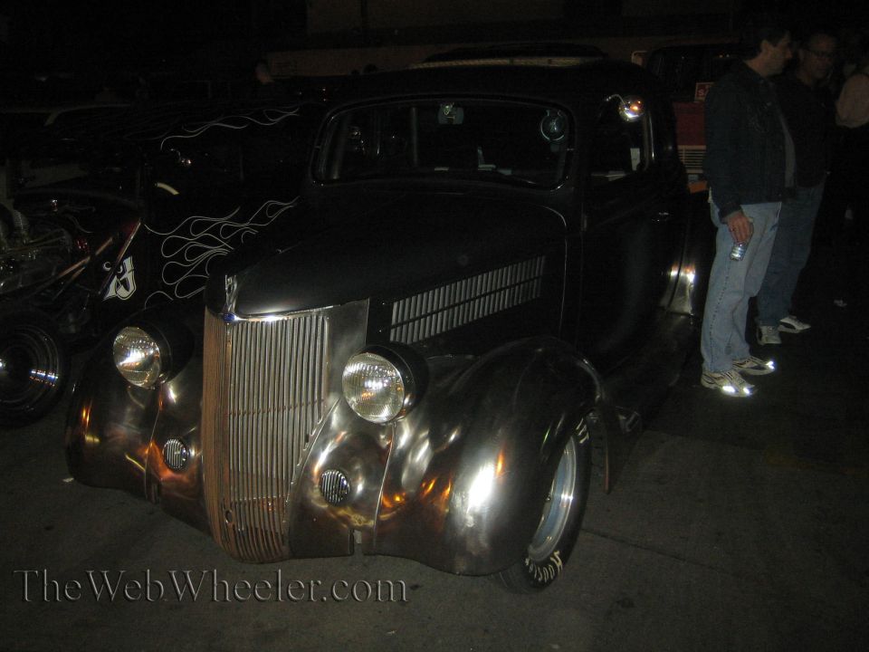 Chrome hot rod with flame decals on the side, seen from the front