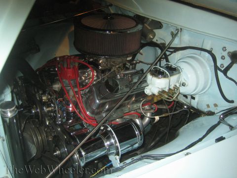 1968 Ford Mustang - Close-up view of a V8 engine in a car's engine bay, chrome components.