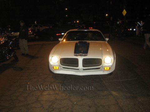 1968 Ford Mustang - This white 1970s Pontiac Firebird is seen from the front at night, a distinctive black hood decal.