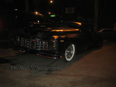 1968 Ford Mustang - A custom hot rod with flame paint and whitewall tires is parked at night.