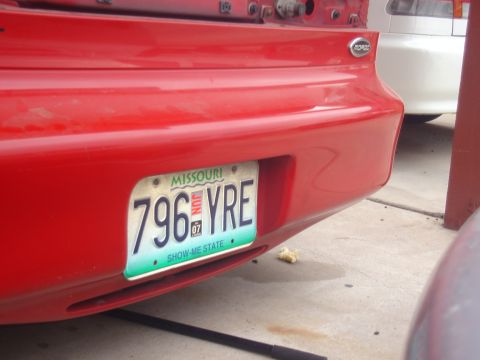 1997 Ford Probe - The rear of a red vehicle is shown, a Missouri license plate with the number 796 YRE.