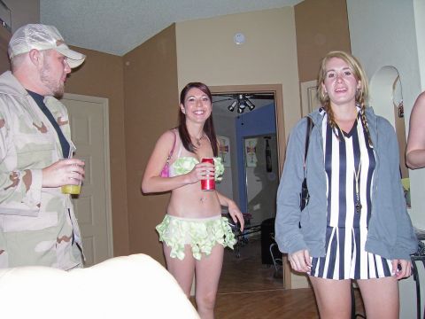 1991 Ford Bronco - Three people in costumes are gathered indoors, possibly at a party or event.