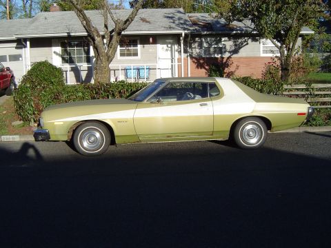 1973 Ford Torino - A two-tone 1974 Ford Gran Torino is parked in front of a house on a sunny day.