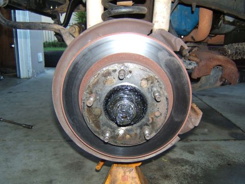 1988 Ford Bronco - The wheel hub assembly is exposed, revealing the greased axle splines and brake rotor mounting points.