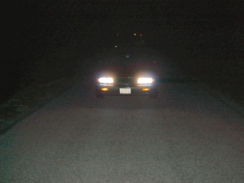 1985 Mercury Grand Marquis - Front view of a 1985 Mercury Grand Marquis at night, headlights illuminated.