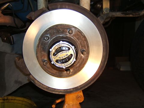 1988 Ford Bronco - A close-up view of a Warn locking hub assembly on a vehicle's brake rotor.