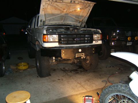 1988 Ford Bronco - Front view of a white 1988 Ford Bronco with its hood open, parked in a garage.