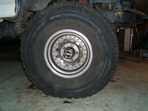 1988 Ford Bronco - Close-up of a 1988 Ford Bronco's front wheel, showing the tire and hub assembly.