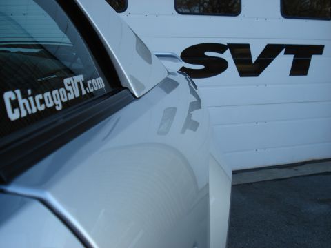 1998 Ford Taurus - A silver car is parked in front of a garage door with an SVT logo and a ChicagoSVT.com sticker on the window.