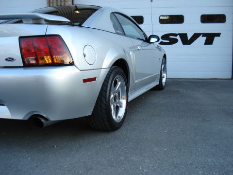1998 Ford Taurus - Silver coupe with SVT badging on garage door, rear 3/4 view.