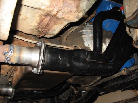 1973 Ford Ranchero - Underneath view of custom exhaust headers and piping, showing a welded flange joint.