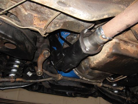1973 Ford Ranchero - A close-up view of the exhaust system and drive shaft components underneath a vehicle.
