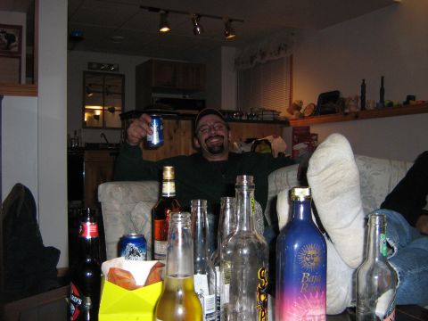 1995 Ford Bronco - A man enjoys a casual evening with friends, surrounded by drinks and snacks.