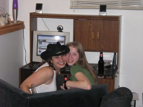 1995 Ford Bronco - Two women smile for the camera in a casual indoor setting with a computer and a beer bottle visible.
