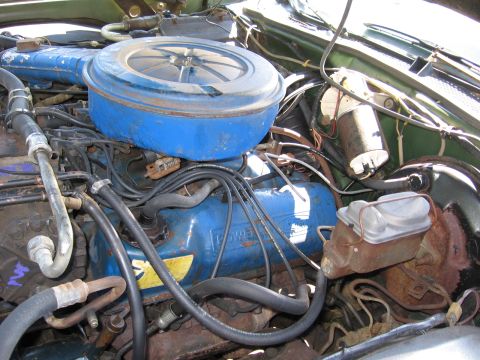 1973 Ford Ranchero - Close-up view of an engine bay, blue valve covers with "POWER" visible and a blue air cleaner assembly.