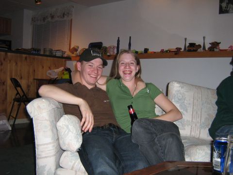 1995 Ford Bronco - A couple relaxes on a couch, sharing a moment of laughter and a drink.
