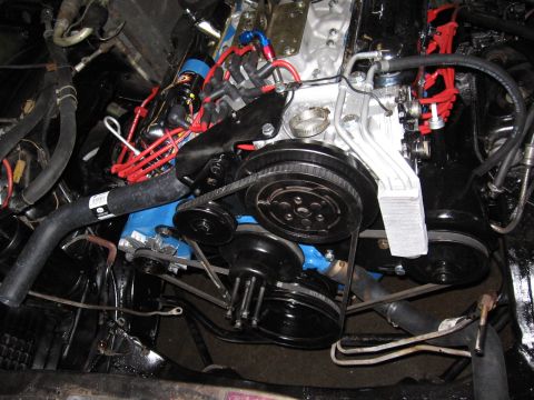 1973 Ford Ranchero - Close-up view of an engine bay, a blue-painted engine block and various black mechanical components.