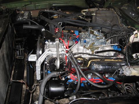 1973 Ford Ranchero - Close-up view of a Ford V8 engine, a prominent carburetor and chrome valve covers.