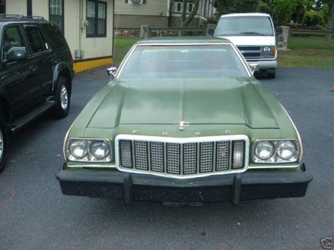 1973 Ford Ranchero - Front view of a green 1973 Ford Ranchero with a prominent grille and dual headlights.