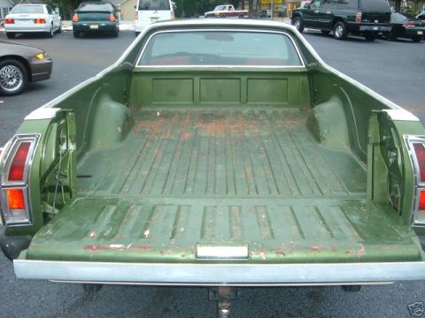 1973 Ford Ranchero - The rear view of a green 1973 Ford Ranchero pickup truck, showing its bed and tailgate.