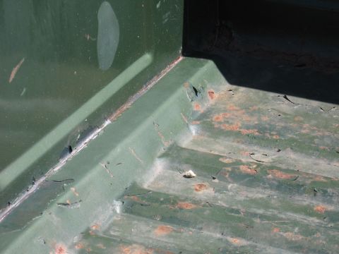 1973 Ford Ranchero - Close-up of a rusted corner in a vehicle's cargo area, showing signs of age and wear.