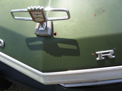 1973 Ford Ranchero - Close-up of the hood ornament and 'R' emblem on a 1973 Ford Ranchero.