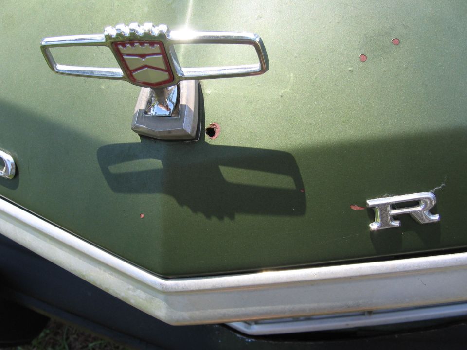 1973 Ford Ranchero hood ornament and 'R' emblem on green paint