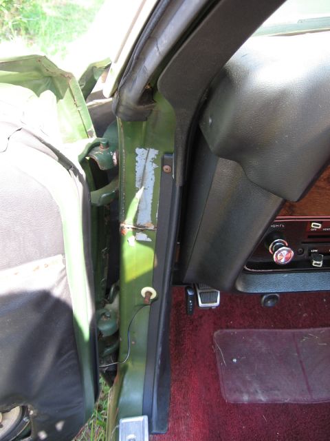 1973 Ford Ranchero - Close-up view of the interior door jamb and dashboard of a vehicle.