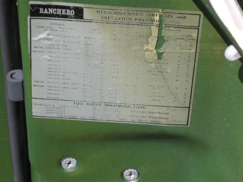1973 Ford Ranchero - A close-up of a vehicle's door reveals a placard with tire information and load capacities.