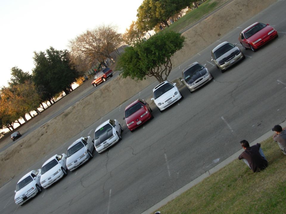 Several Ford Taurus sedans parked in a lot, angled view
