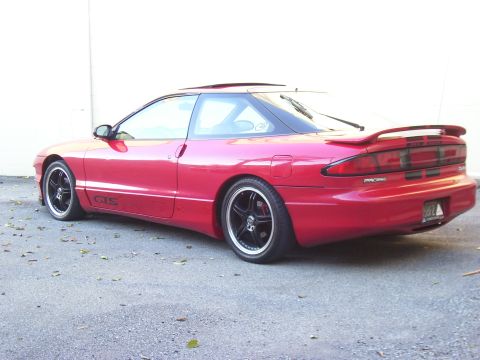 1997 Ford Probe - This red coupe has a sporty design with a rear spoiler and custom black rims.