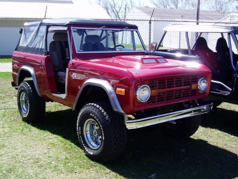 1986 Ford Bronco - This red Ford Bronco features a removable soft top and a classic grille.