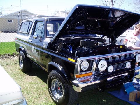 1986 Ford Bronco - This classic Ford Bronco has its hood open, revealing the engine bay and custom lighting on the grille.