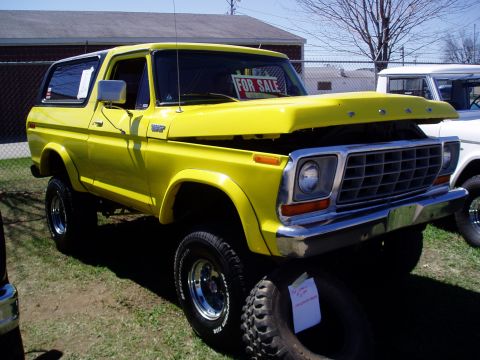 1986 Ford Bronco - Yellow 1978 Ford Bronco for sale at a swap meet, hood is open.