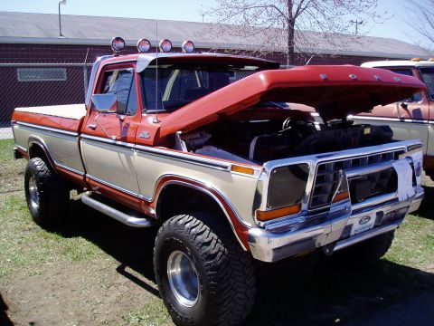 1986 Ford Bronco - This lifted Ford F-Series pickup truck, likely from the late 1970s, is parked outdoors with its hood open.