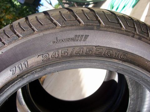 1978 Ford Mustang II - This image shows a close-up of a tire, displaying its size and rotation direction.