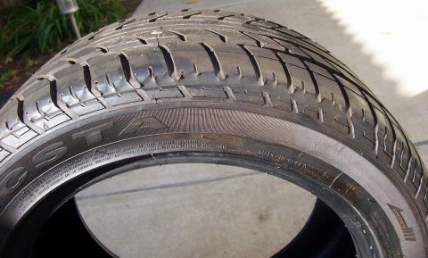 1978 Ford Mustang II - A close-up view of a tire, showing its tread and sidewall markings.